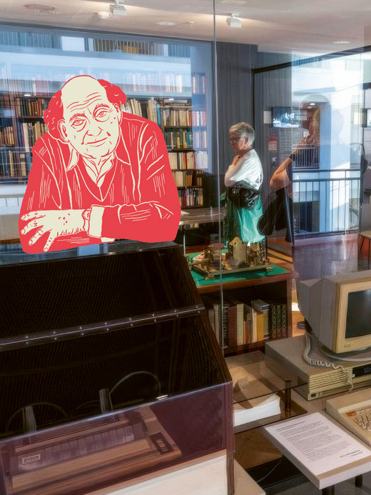 A museum exhibit featuring vintage computer equipment and a digital artwork of an older man in a red outline. Visitors are observing the displays, and shelves filled with books are visible in the background.