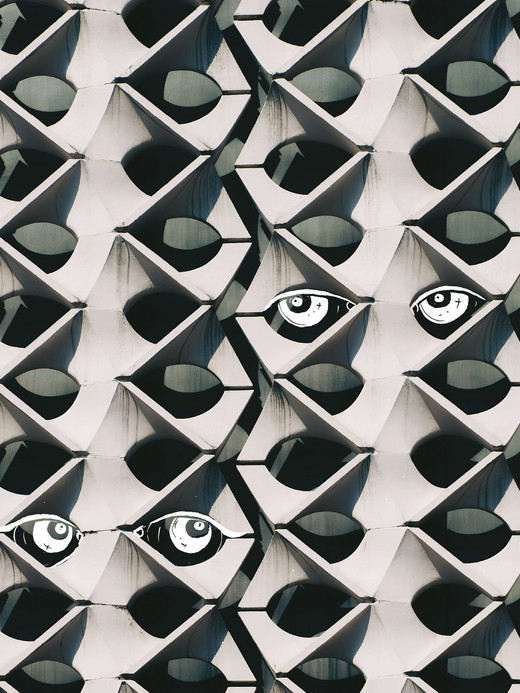 A geometric pattern of interlocking, rounded white shapes fills the image. Two stylized black and white eyes are strategically placed among the shapes, giving the appearance of peering through the design.